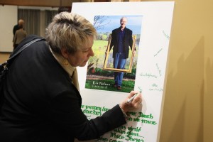 Sue Briskey signing the artwork memorabilia canvas. PHOTO: Katharyn Brine